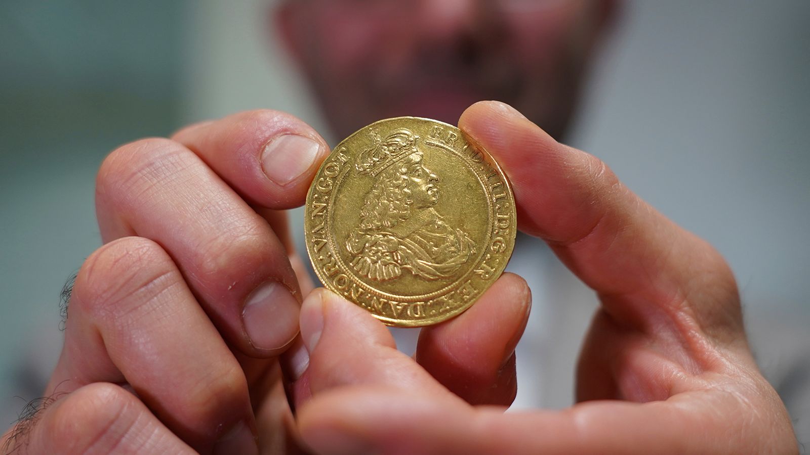 Vicken Yegparian, vice president of numismatics, Stack's Bowers Galleries, holds a golden coin once belonging to the collection of Danish king, Frederik VII, now part of L. E. Bruun's collection, in Zealand, Denmark, May 7, 2024.