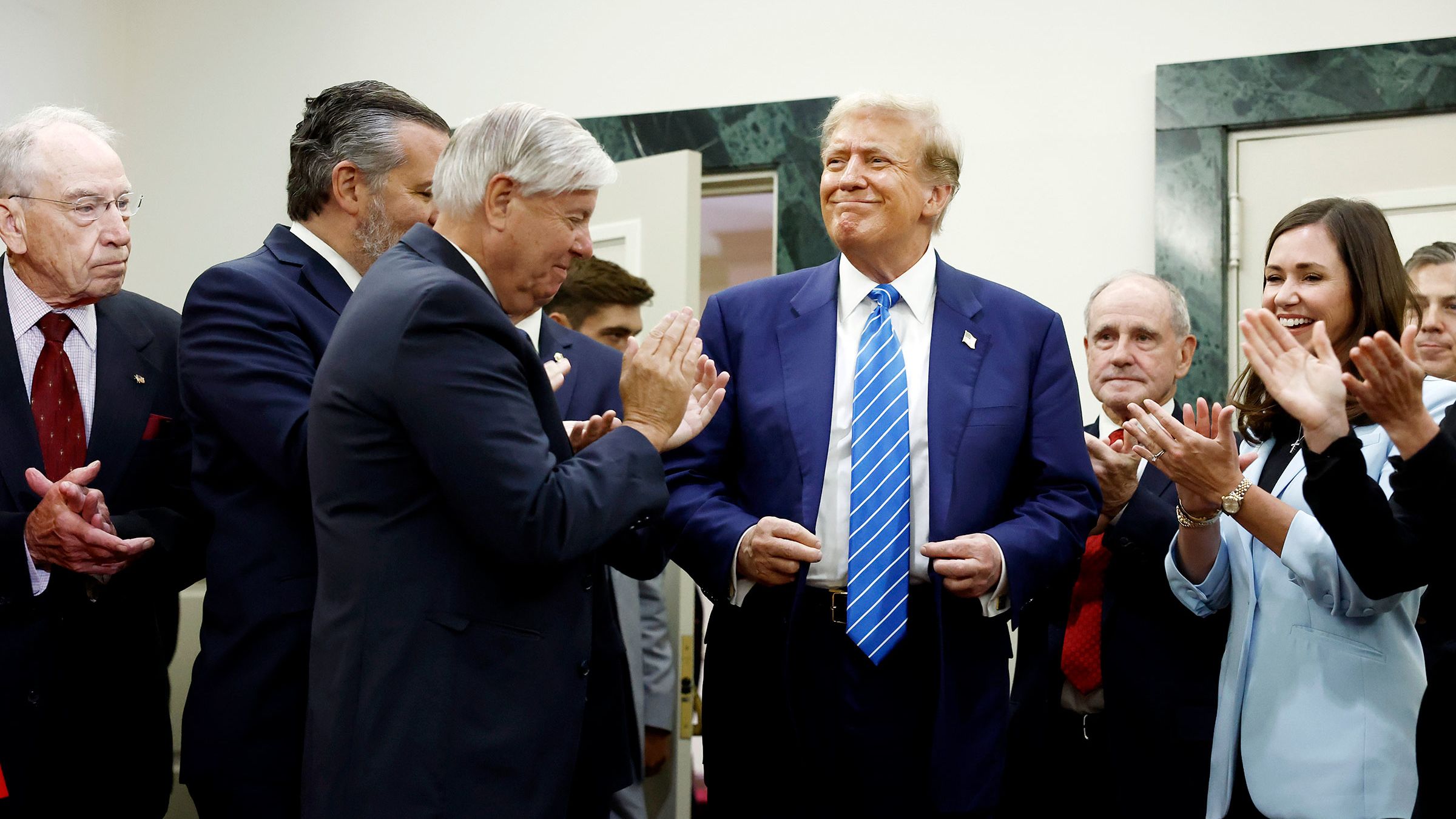 Former President Donald Trump is applauded by Senate Republicans before giving remarks to the press at the National Republican Senatorial Committee building on June 13, 2024 in Washington, DC.