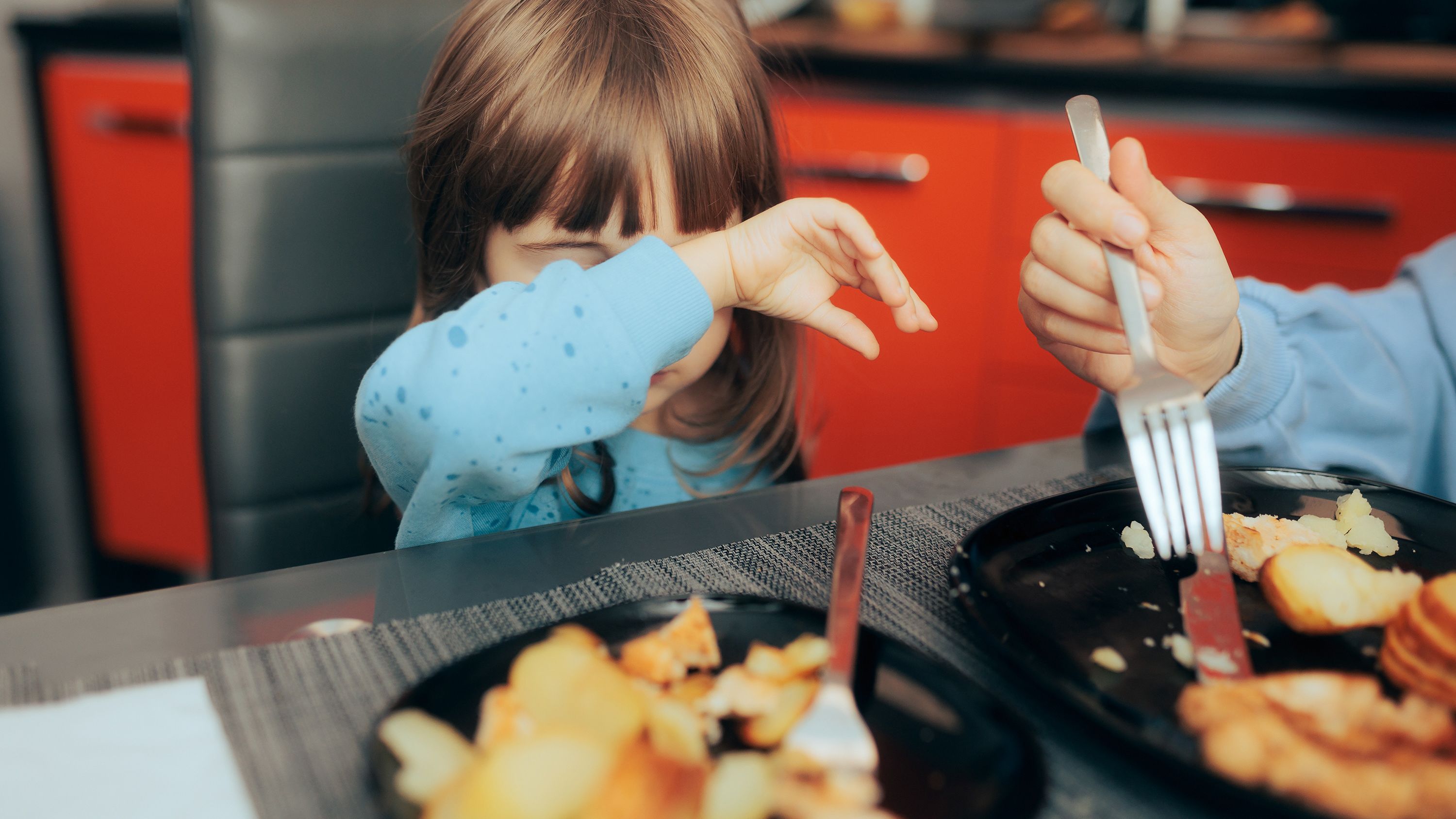 Little child rejecting food option for lunch