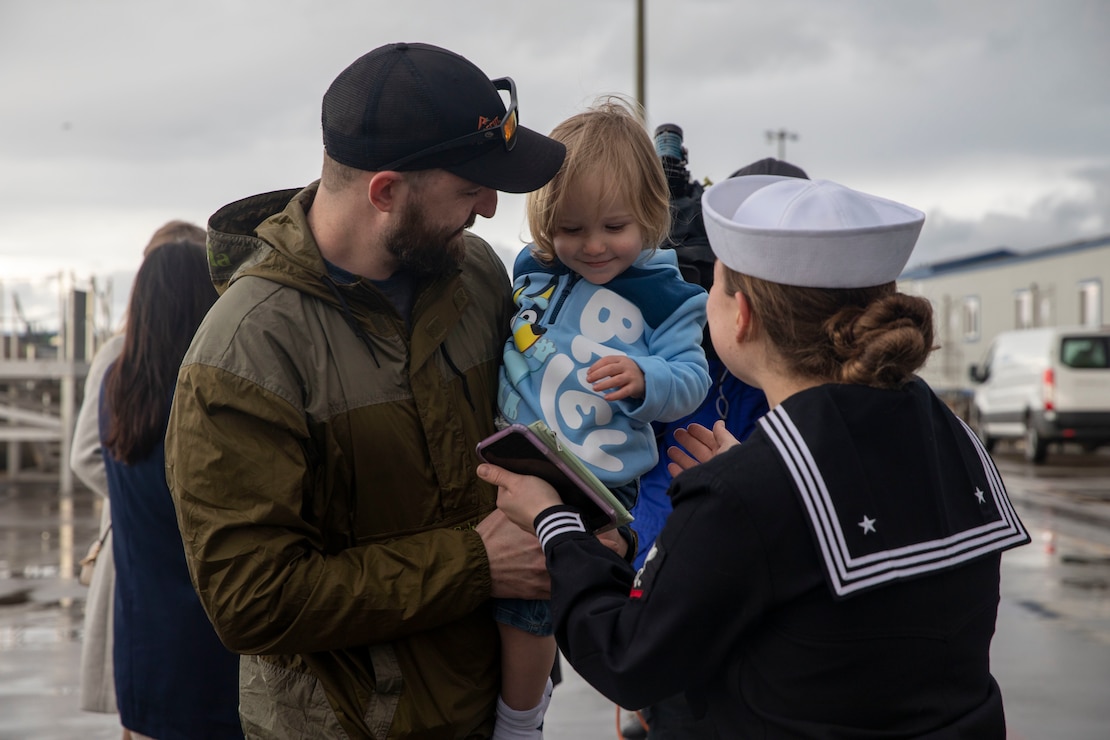 A Sailor reunites with her family after Arleigh Burke-class guided-missile destroyer USS McCampbell (DDG 85) arrived to its new homeport of Naval Station Everett, Washington April 8, 2022. Prior to relocating, the ship underwent an extensive Depot Modernization Period in Portland, Oregon that spanned more than 18 months. The modernization included improvements to the hull, mechanical systems, electrical technology, wireless communications, and weapon upgrades. This routine maintenance ensures the ship can continue to be mission capable throughout its expected service life.