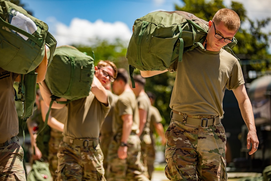 U.S. Army Soldier Pvt. Christopher Dotson, infantryman with 101st Airborne Division (Air Assault), carries a duffel bag at Brazil’s 5th Light Infantry Battalion in Lorena, Brazil, Dec. 1, 2021. U.S. and Brazilian army soldiers took part in Exercise Southern Vanguard 2022, the largest deployment of a  U.S Army unit to train with the Brazilian army forces in Brazil. (U.S Army photo by Pfc. Joshua Taeckens)