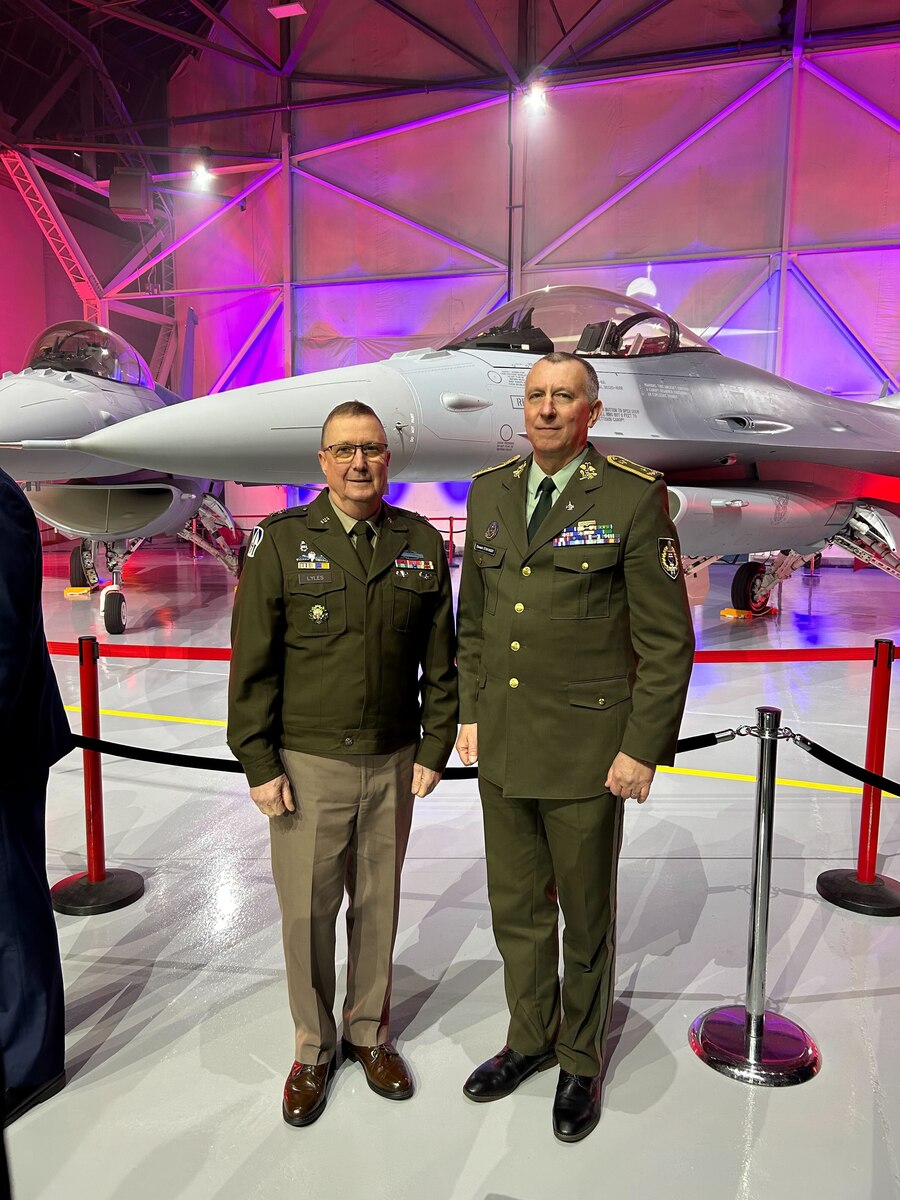 Indiana National Guard Maj. Gen. Dale Lyles, Indiana adjutant general, and Brig. Gen. Slavomir Staviarsky, a Slovak Republic defense attaché, pose in front of F-16s at a ceremonial delivery event in Greenville, South Carolina, Feb. 29, 2024.
