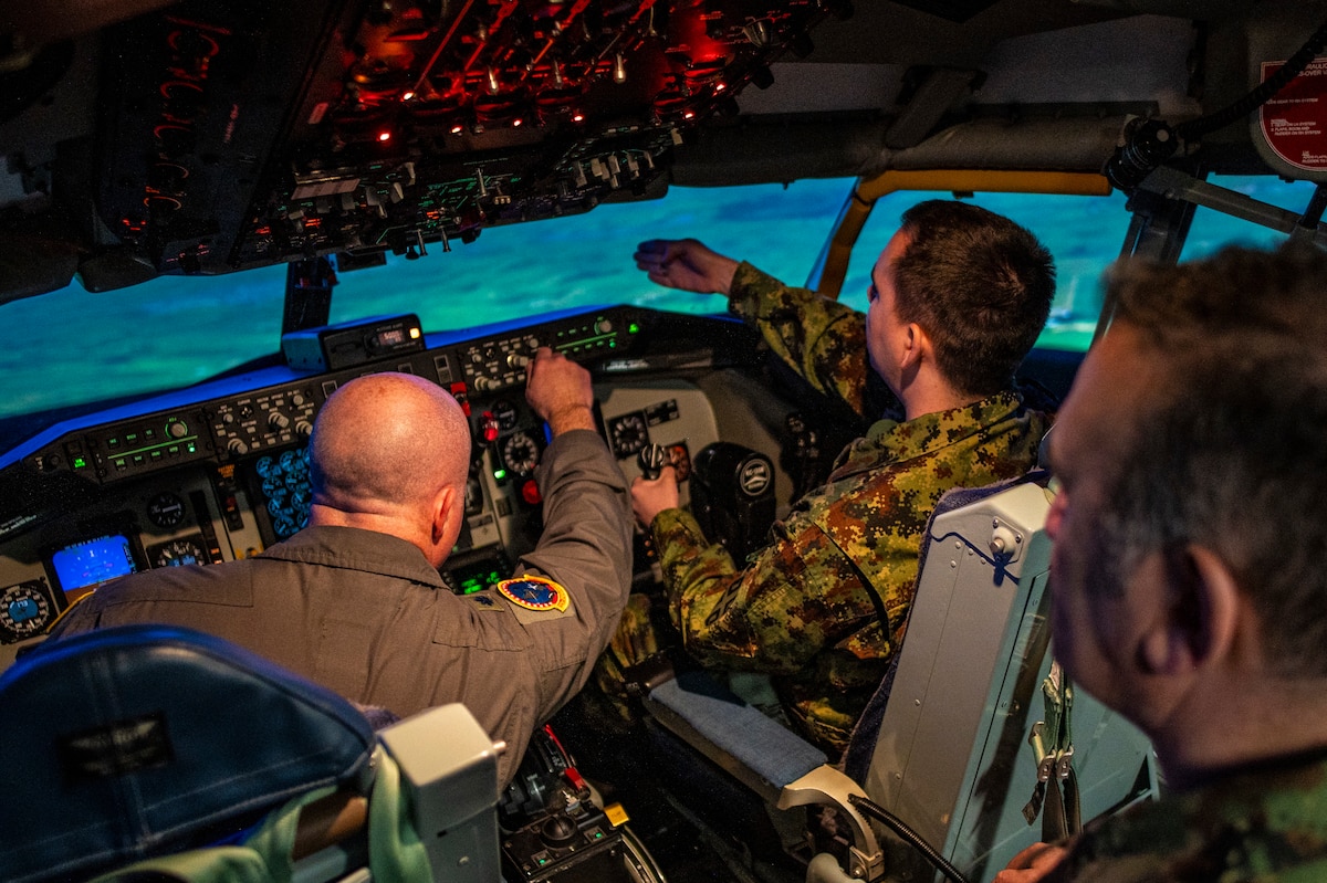 A delegation of Serbian Armed Forces cyber professionals visit Airmen of the 121st Air Refueling Wing at Rickenbacker Air National Guard Base, Ohio, March 6, 2024. During their visit as part of the State Partnership Program, the Serbians toured a KC-135 Stratotanker and tried a flight simulator.