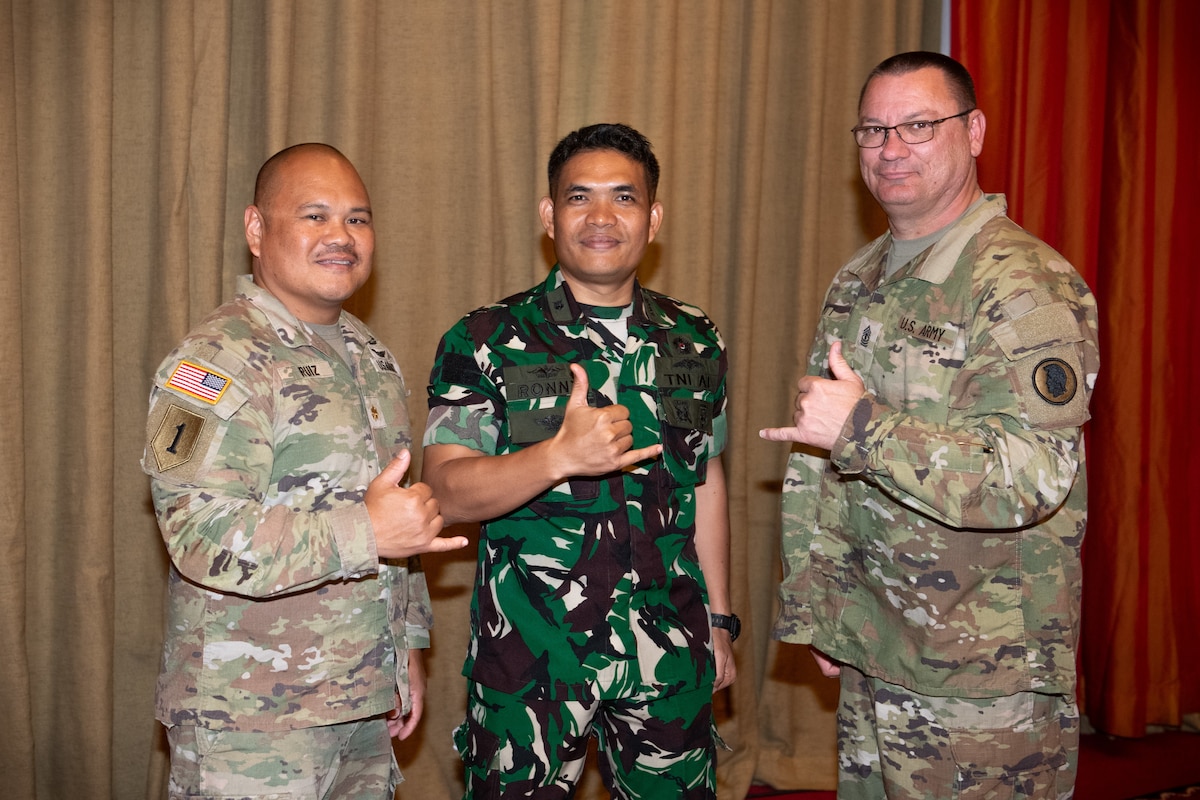 Tentara Nasional Indonesia Lt. Cdr. Ronny Basirun Simatupang, Indonesia Armed Forces Surgeon General Headquarters staff officer and emergency nurse, center, and Hawaii Army National Guard State Partnership Program medical representatives, Maj. Ryan Ruiz and 1st Sgt. Aaron Pitts, celebrate the completion of a bilateral defense discussions midterm review May 7, 2024, at Jakarta, Indonesia.