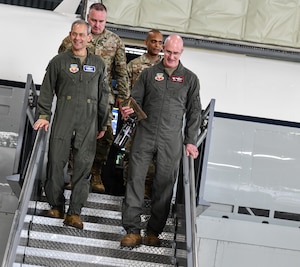 U.S. Air Force Gen. Ken Wilsbach, commander of Air Combat Command, exits an RC-135 RIVET JOINT with Col. Mark Howard, 55th Wing commander, Chief Master Sgt. David Wolfe, ACC command chief, and Chief Master Sgt. Andrew Small, 55th Wing command chief on Aug. 19, 2024, at Offutt Air Force Base.