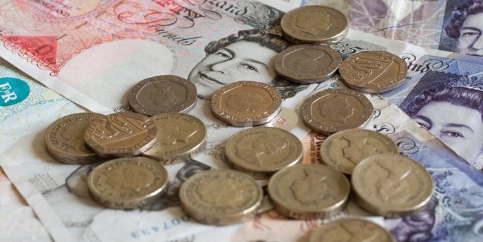 A close-up image of pound coins and notes