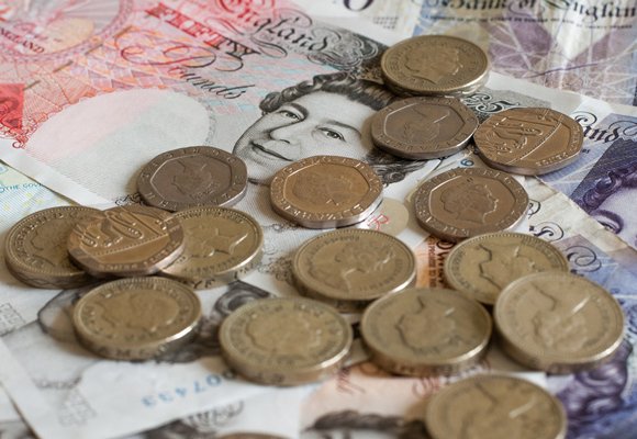 A close-up image of pound coins and notes