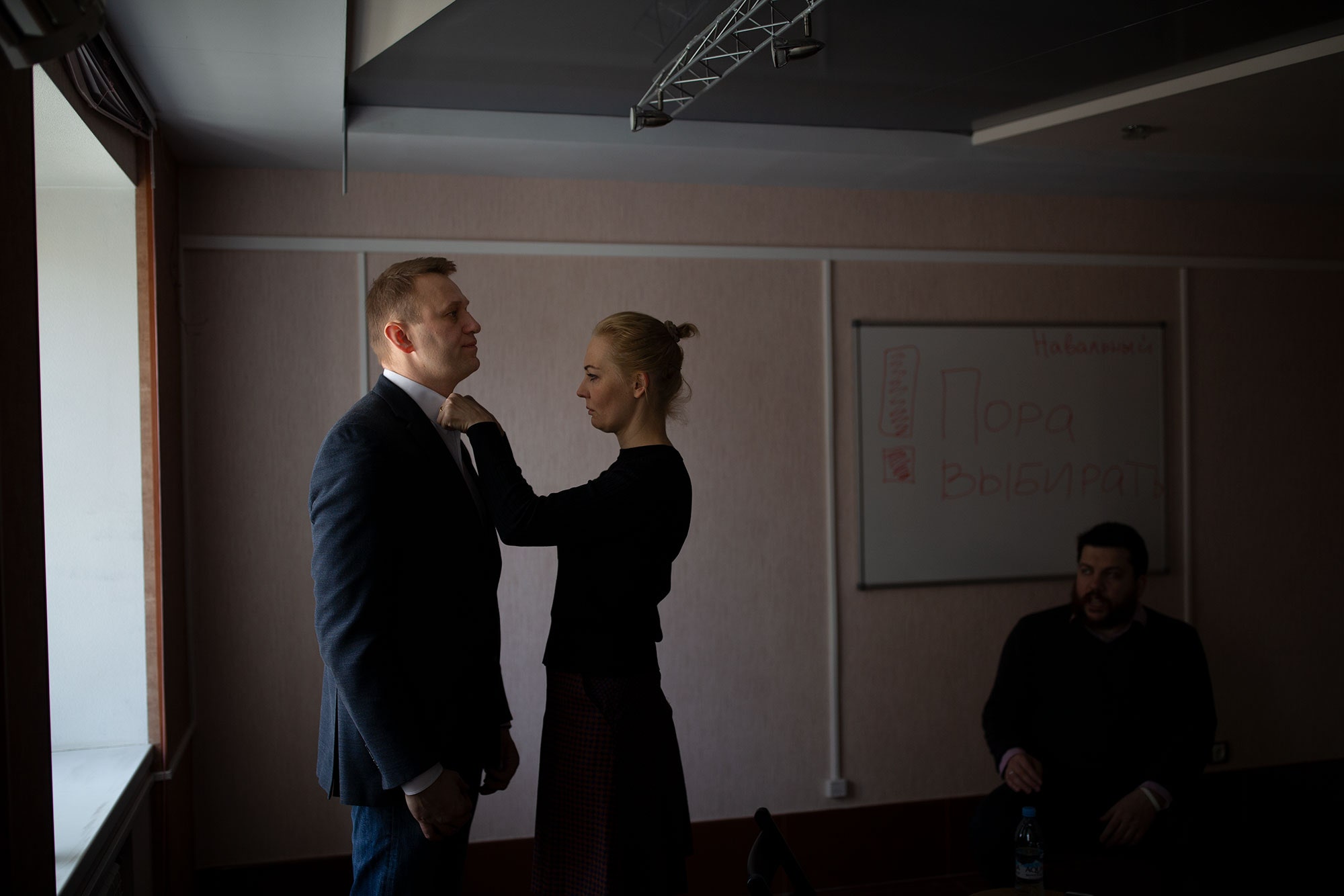 Image may contain Human Person Alexei Navalny Indoors Room Clothing Suit Coat Overcoat Apparel and Furniture