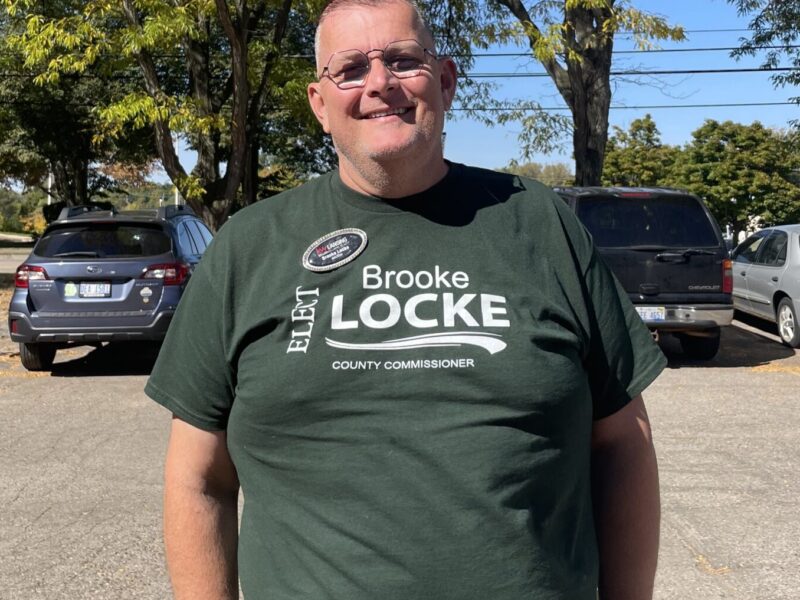 Locke stands in front of a Okemos Biggby Coffee shop.