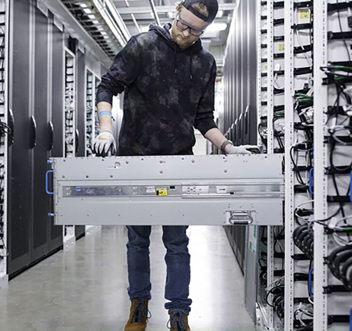 Man working on a server rack in a datacenter