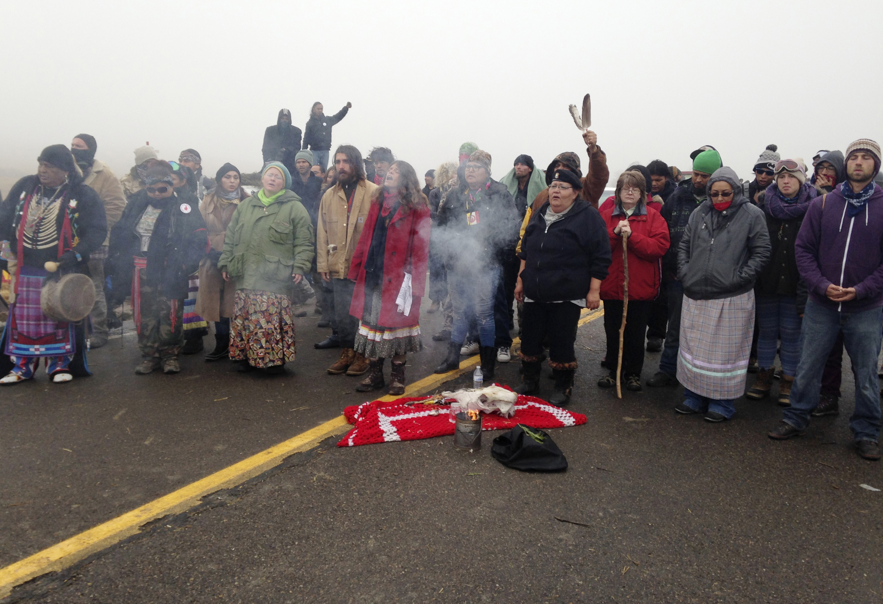 Protesters against the construction of the Dakota Access oil pipeline burn sage amid the fog surrounding the protest camp near Cannon Ball, N.D.