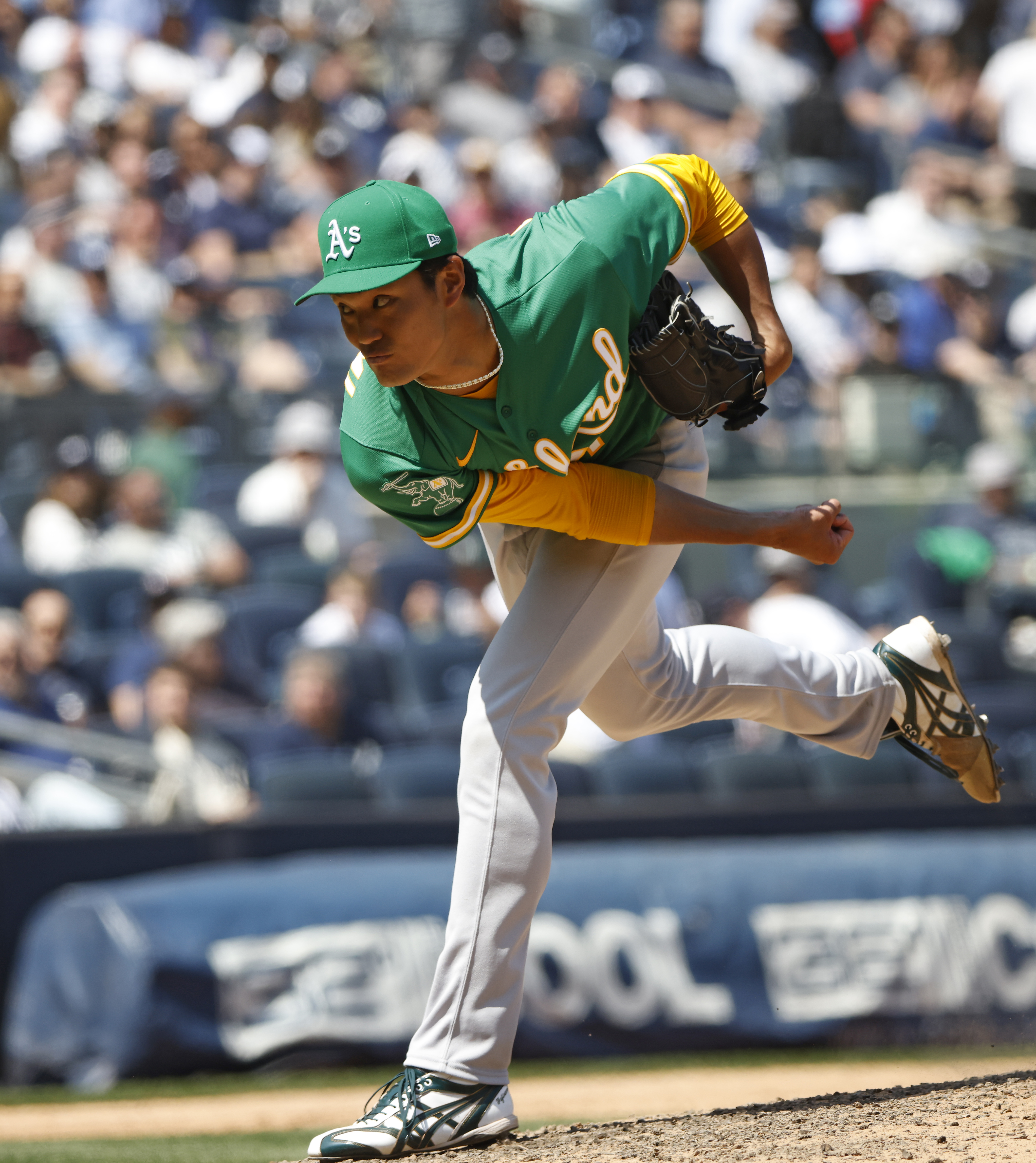 Shintaro Fujinami #11 of the Oakland Athletics throwing a pitch during a baseball game between the Athletics and New York Yankees.