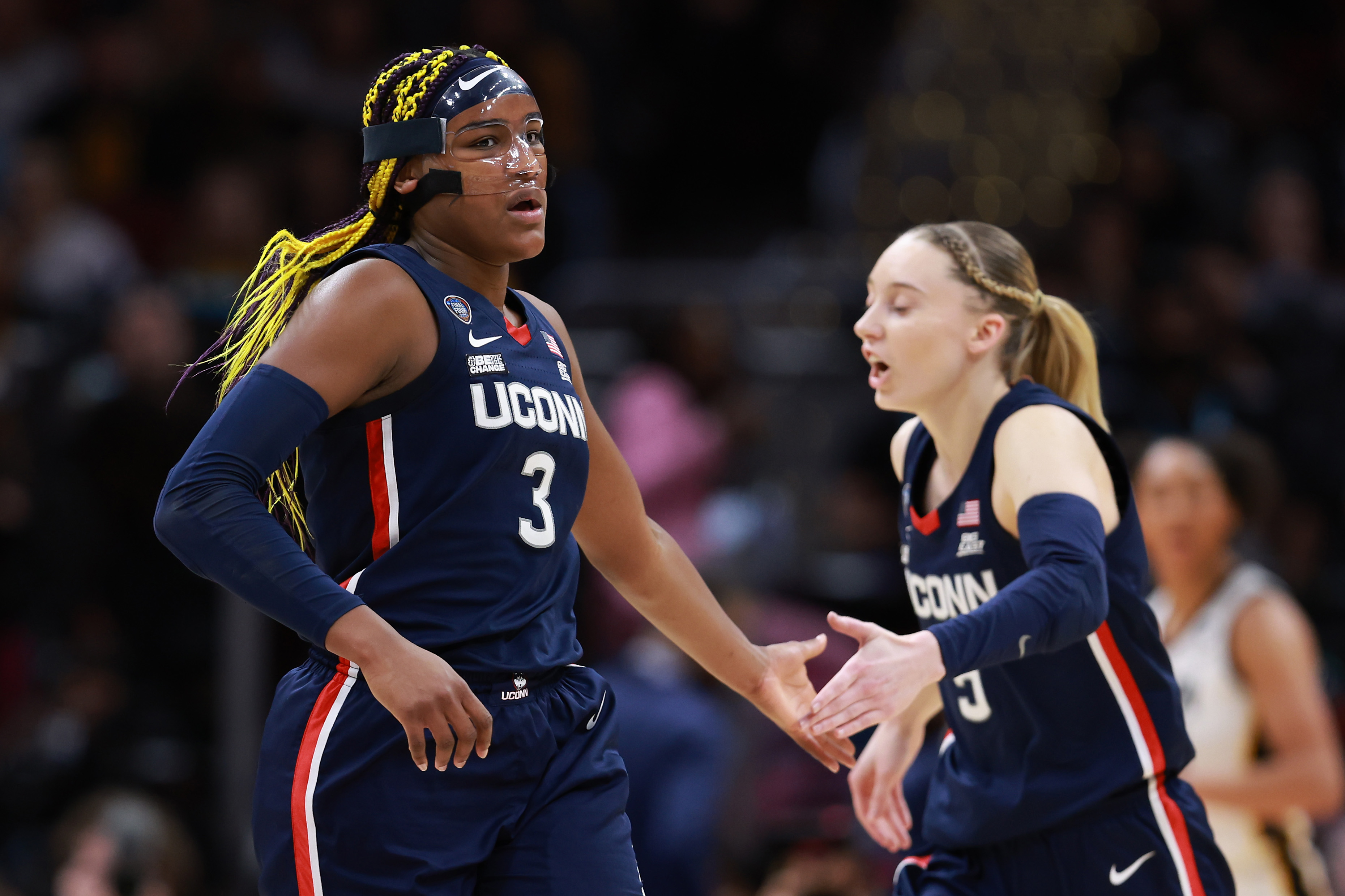 Aaliyah Edwards and Paige Bueckers of the UConn Huskies reacting during the NCAA Women's Basketball Tournament Final Four semifinal game against the Iowa Hawkeyes