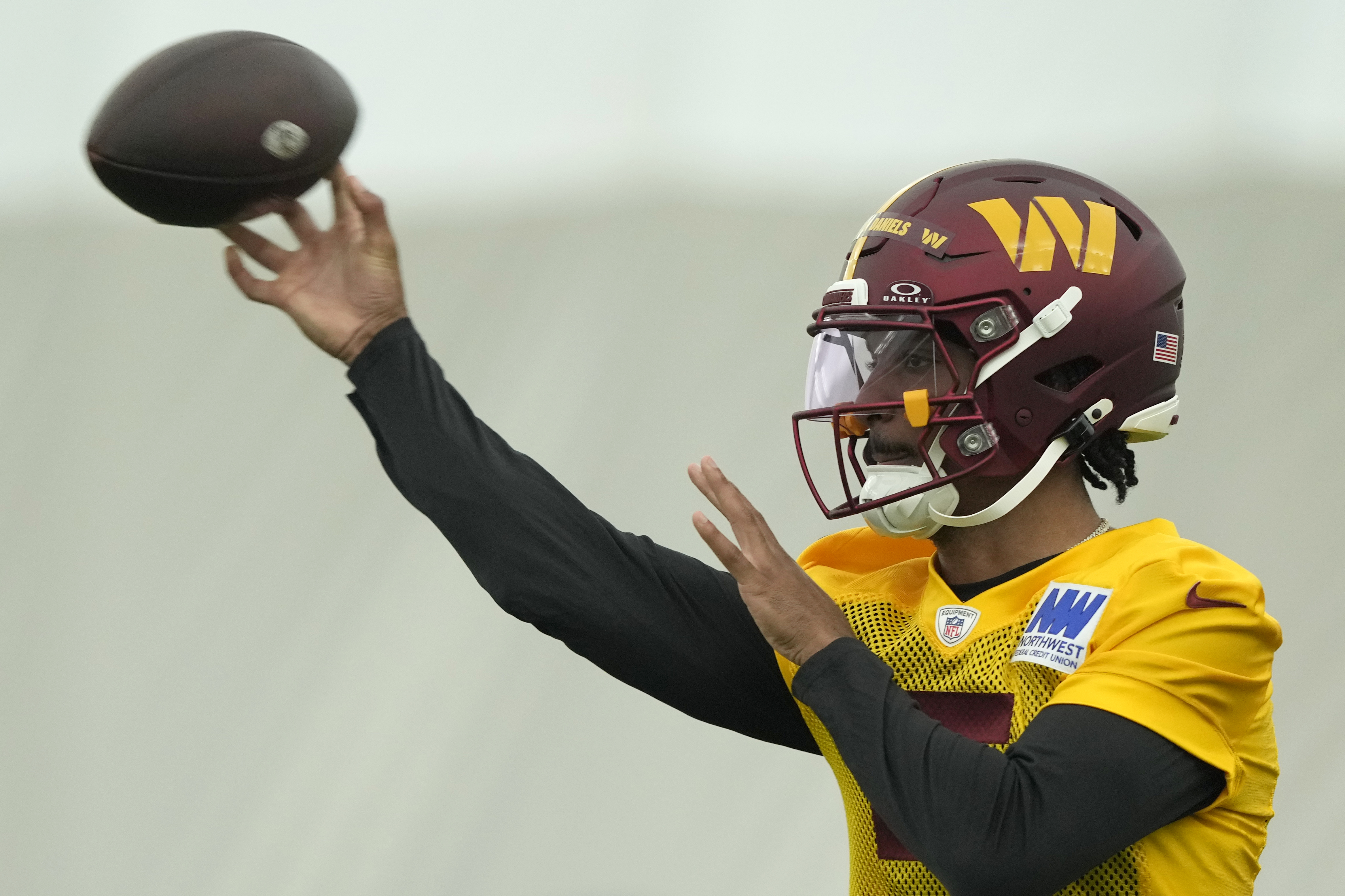 Washington Commanders first round draft pick quarterback Jayden Daniels warms up during an NFL rookie minicamp football practice in Ashburn, Va., Friday, May 10, 2024. 