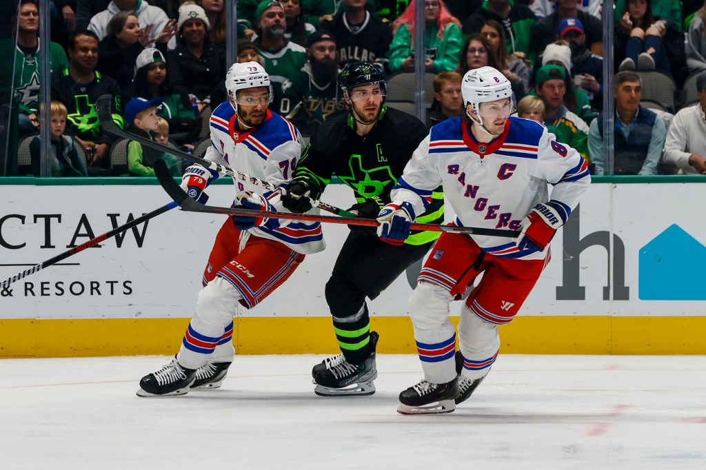 Dallas Stars center Tyler Seguin (91), New York Rangers defenseman K'Andre Miller (79) and defenseman Jacob Trouba (8) look for the puck during the game between the Dallas Stars and the New York Rangers on October 29, 2022 at American Airlines Center in Dallas, Texas