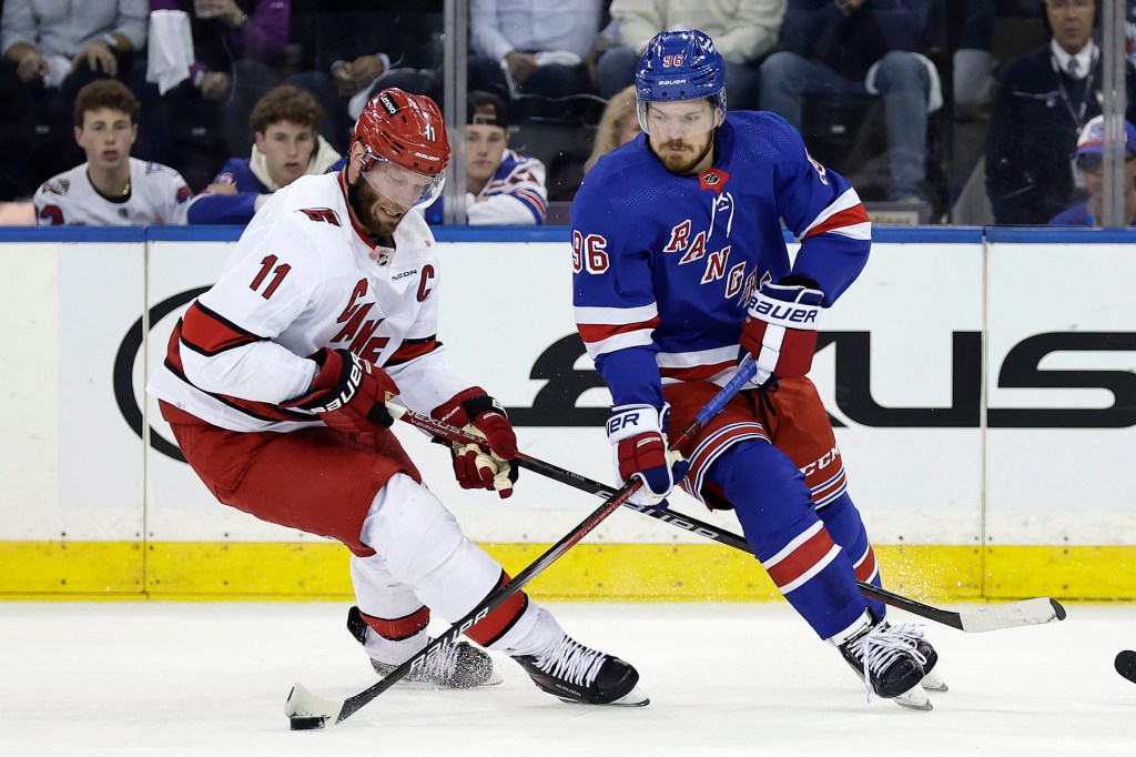 New York Rangers center Jack Roslovic (96) skates with the puck past Carolina Hurricanes center Jordan Staal in the first period during Game 5 of an NHL hockey Stanley Cup second-round playoff series, Monday, May 13, 2024, in New York.