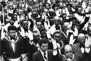 A black and white photograph of a large crowd of African American men in Masonic dress