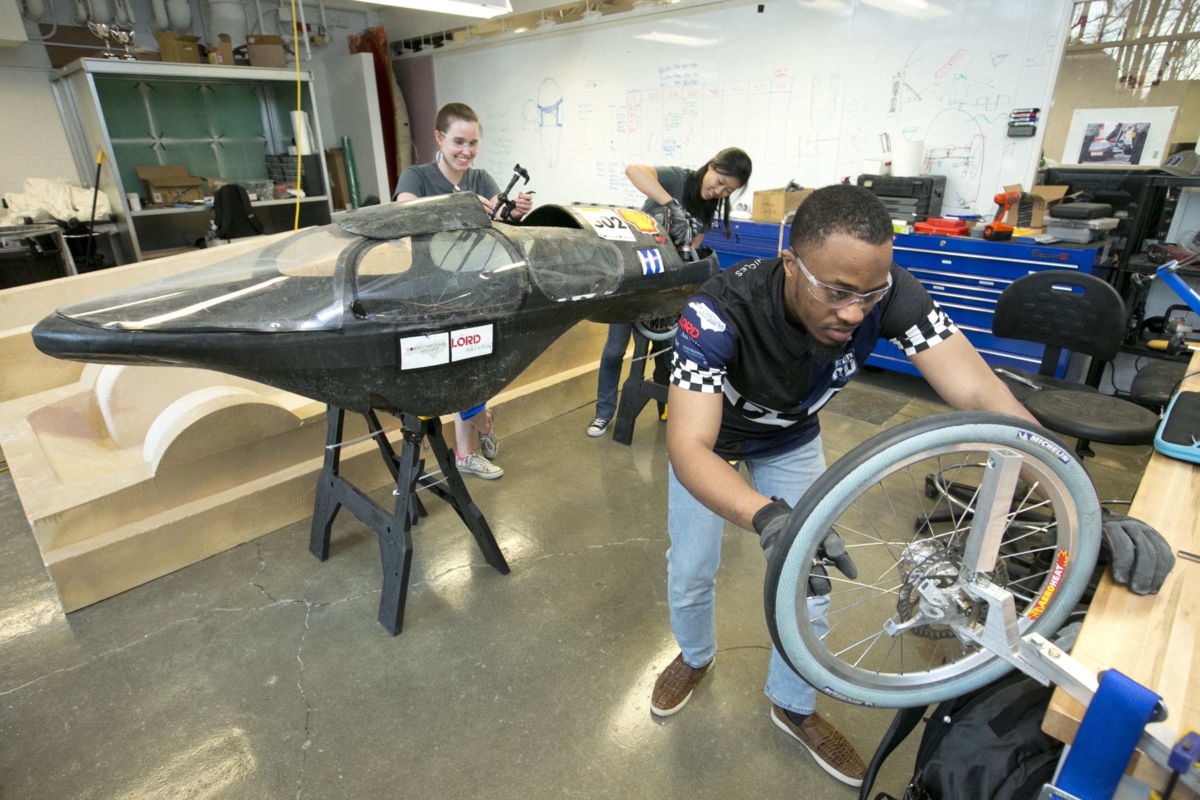 undergraduates work to build an electric powered vehicle for competitions