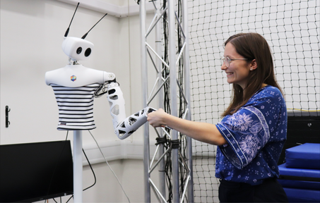Researcher handshake with robot