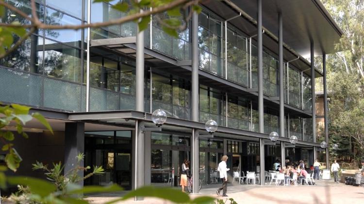 Photo of the Wollongong Campus Library, with large glass windows, from the outside view