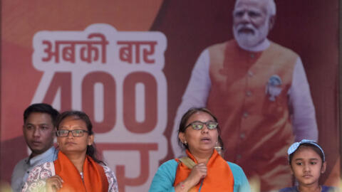 Supporters of Bharatiya Janata Party watch the proceedings of counting of votes on a television screen at their party office in Gandhinagar, India, Tuesday, June 4, 2024. Prime Minister Narendra Modi'