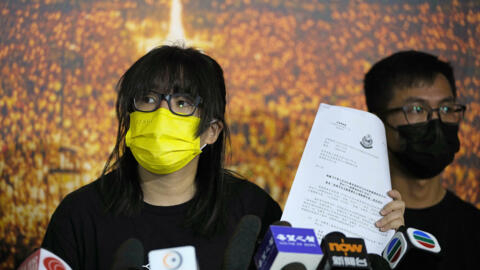 Chow Han Tung, vice chairwoman of the Hong Kong Alliance in Support of Patriotic Democratic Movements of China, shows a document from the police department during a news conference in Hong Kong, September 5, 2021.