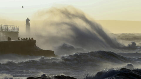 Waves crash against the sea wall at Porthcawl, south Wales, on February 18, 2022 as Storm Eunice brings high winds across the country. 