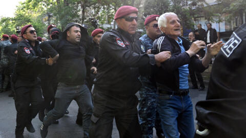Armenian law enforcement officers detain a protester during a rally to demand Prime Minister Nikol Pashinyan's resignation over a land transfer to neighbouring Azerbaijan, Yerevan, May 27, 2024.