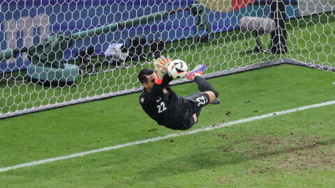 Portugal goalkeeper Diogo Costa saves a penalty during the Euro 2024 round of 16 football match between Portugal and Slovenia at the Frankfurt Arena in Frankfurt am Main on July 1, 2024.