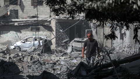 A Palestinian inspects the debris to buildings following an operation by the Israeli Special Forces in the Nuseirat camp, in the central Gaza Strip on June 8, 2024.