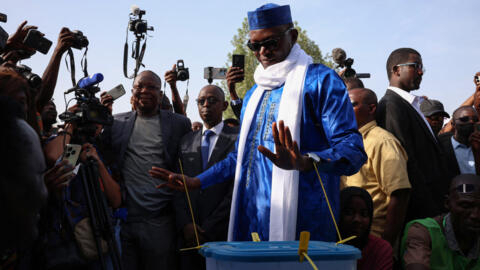 Chad's transitional Prime Minister and Les Transformateurs party presidential candidate Succes Masra (C) reacts after casting his ballot at the Bureau de vote numéro 1 polling station in Carre 30, Abe