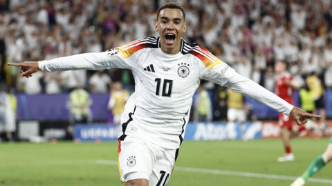 Jamal Musiala celebrates scoring Germany's second goal against Denmark