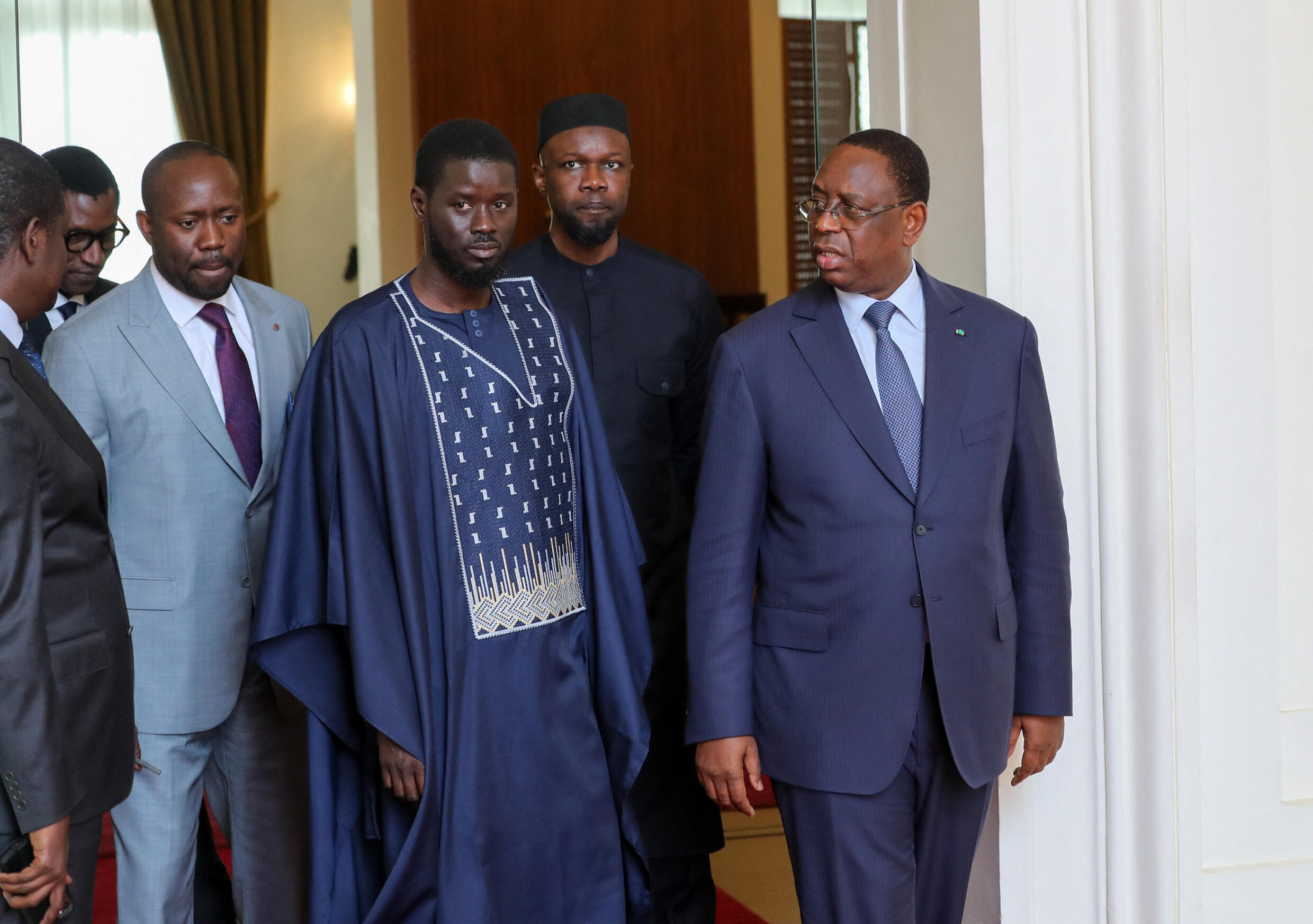 This handout picture distributed by the Senegalese Presidency on March 28, 2024 shows Ousmane Sonko (2nd R), outgoing President Macky Sall (R) and president-elect Bassirou Diomaye Faye.