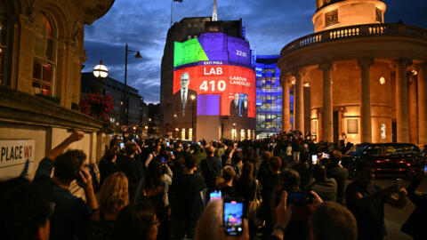 An exit poll predicting that the Labour Party led by Keir Starmer will win 410 seats in Britain's general election is projected onto BBC Broadcasting House in London on July 4, 2024. Labour is set for