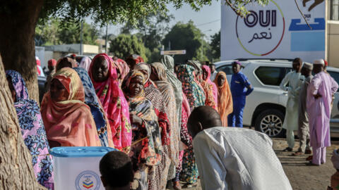 Women queue to cast their votes during the constitutional referendum at a polling station in N'Djamena, on December 17, 2023.