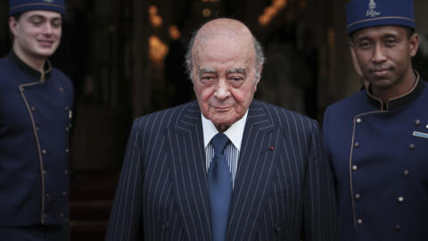 Egyptian businessman Mohamed Al Fayed poses with hotel staff in Paris, June 27, 2016.