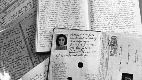 Photo of Anne Frank's passport on top of the diary she kept while confined to the 'secret annex' in Amsterdam, where she hid with her family from the Nazis between June 1942 and August 1944.