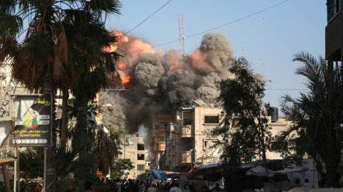 عمود من النار والدخان تتصاعد بعد لحظات من غارة جوية إسرائيلية استهدفت مبنى سكنيا في مدينة البريج وسط قطاع غزة في 3 يونيو 2024.