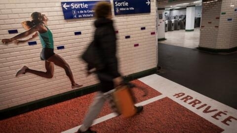 A woman walks through a decorated metro station to celebrate Paris being named host of the 2024 Olympic Games.