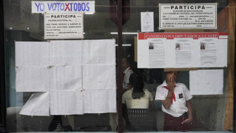 A boy peers from the window of a polling station during the legislative elections in Havana, Cuba, March 26, 2023.