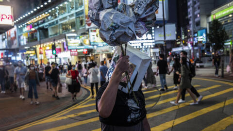 An artist takes part in a performance art in the Causeway Bay district of Hong Kong on June 3, 2021, to mourn the victims of China's deadly Tiananmen Square crackdown after authorities banned an annual vigil.