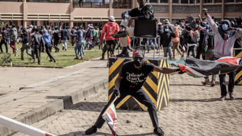 Protesters hold flags and chant anti-government slogans inside the Kenyan Parliament compound after storming the building during a strike to protest tax hikes in downtown Nairobi, on June 25, 2024.