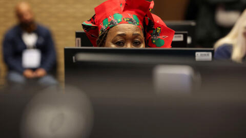 A member of the Economic Freedom Fighters (EFF) sits behind a computer as she waits on results of the South African national election.