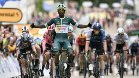 Wanty team's Eritrean rider Biniam Girmay wearing the sprinter's green jersey (C) cycles past the finish line to win the 8th stage of the 111th edition of the Tour de France cycling race, 183,5 km bet