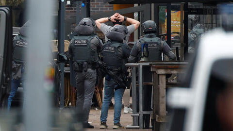 Dutch police officers detain a suspect near the Cafe Petticoat nightclub in Ede, Netherlands, March 30, 2024.