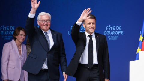 French President Emmanuel Macron, right, and German President Frank-Walter Steinmeier enter the stage of the European Youth Festival, in front of the Church of Our Lady in Dresden, eastern Germany.