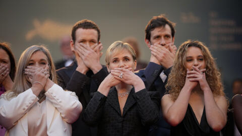 French actor and director Judith Godrèche (centre) poses with hands covering her mouth as she attends the Cannes red carpet premiere of George Miller's "Furiosa: A Mad Max Saga" on May 15, 2024.