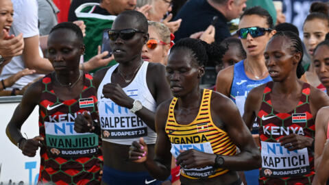 Uganda's Rebecca Cheptegei (centre, yellow shirt) was assaulted at her home in Kenya, police said.