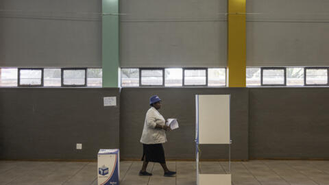 An early voter approaches a voting booth to mark her ballot papers at the Yeoville Recreation Centre in Johannesburg on May 27, 2024.
