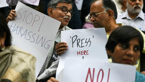 Members of the press hold placards during a protest in New Delhi on October 4, 2023, to condemn the recent arrest of journalists. 